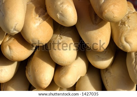 Close-up of stack of fresh crusty French bread, shallow depth of focus.