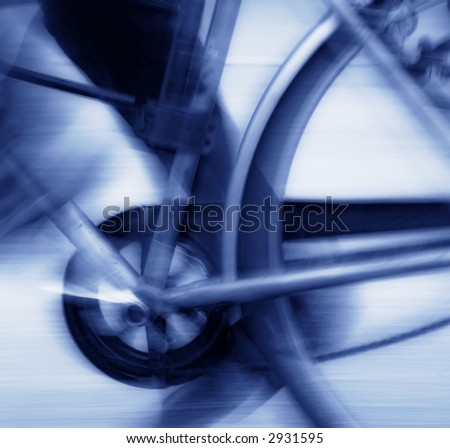 Abstract blur background of bicycle pedal, chain and rear wheel in motion, blue tone