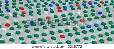 Multi-coloured tops of empty plastic milk containers