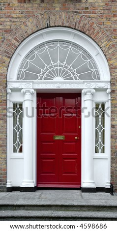 Georgian doorway in Dublin, Ireland, with cast iron fanlight and molded ionic columns