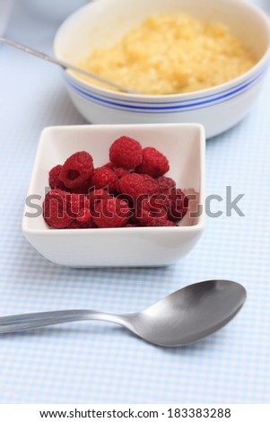 Raspberries and mashed banana closeup on a kitchen table with for making organic paleo cake