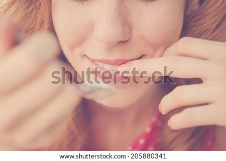 Beautiful Pin-Up Girl eating ice cream, close up. Vintage, retro styled imagery