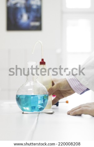 Scientist doing experiments, mixing chemicals and test samples