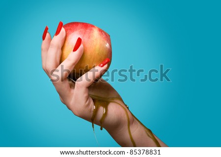 Photo of a hand with long red polished nails, grasping a poisoned apple, posion dripping,