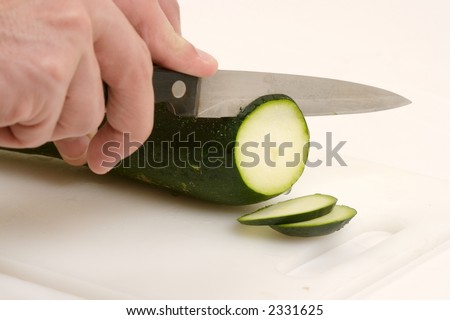 someone cutting a vegetable
