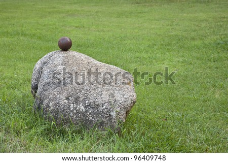 Balance A steel sphere balanced over a rock