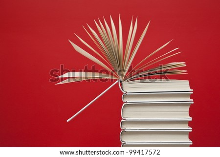 Open book on top of a group of white books