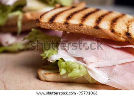 Grilled toast with ham cheese tomato and lettuce