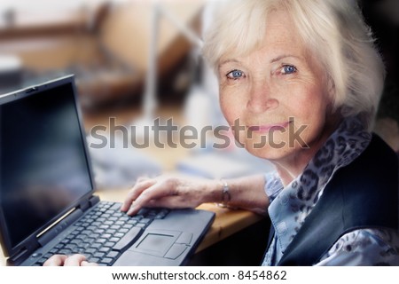 Senior lady with laptop ready to start