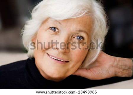 Senior woman portrait, smiling with hand on neck
