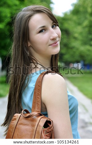 Schoolgirl Outdoor with book bag. Back to School.