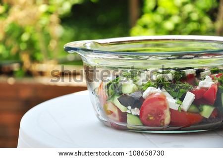 Greek salad in a glass bowl outdoor