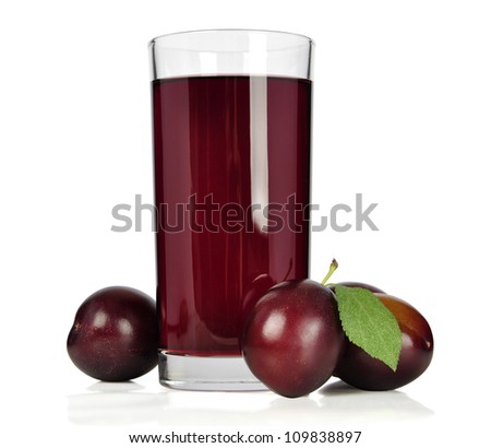 Fresh plums and a glass full of plums juice on a white background