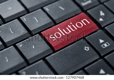 Black keyboard with red solution button on enter key closeup