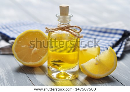 lemon oil in a glass bottle with fresh