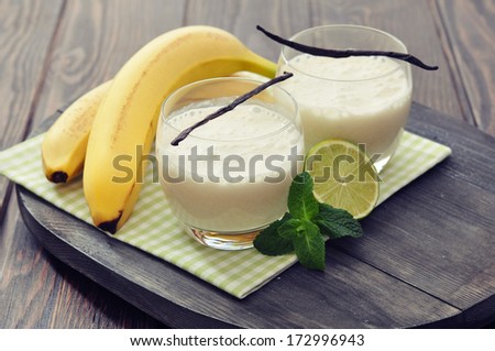 Banana milk shake in glass with vanilla, mint and lime