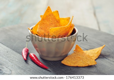Corn nachos in bowl on wooden background