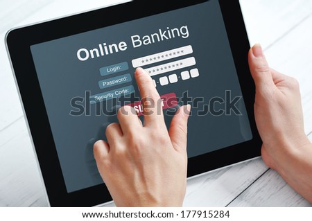 Female hands using online banking on touch screen device
