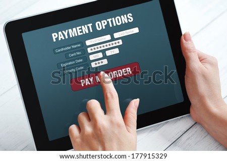 Female hands using touch screen device for online payment