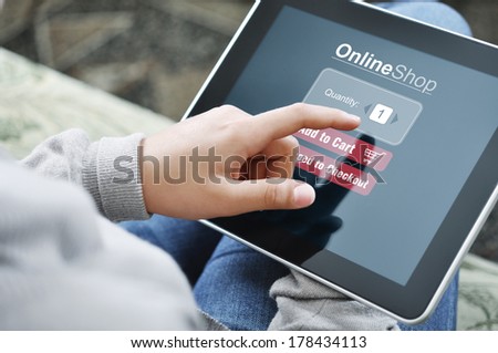 Young woman using touch screen device for online shopping