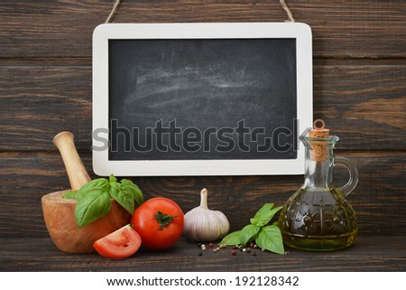 Blackboard with food ingredients on wooden background