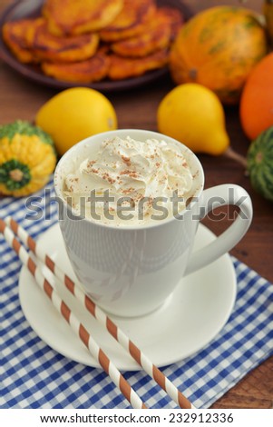Pumpkin spice latter with whipped cream, cinnamon and decorative pumpkins