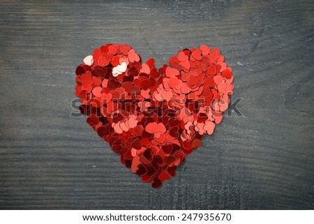 Confetti in shape of heart  on wooden background