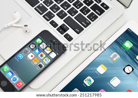 KIEV, UKRAINE - JANUARY 29, 2015: Apple iPhone 5s, iPad Air 2 and MacBook Air. Apple Inc. is an American multinational corporation that designs, develops, and sells consumer electronics.