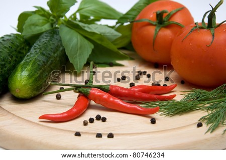 vegetables, herbs and spices on a cutting board isolated