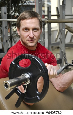 Handsome men lifting weights in the gym