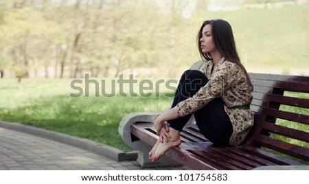 Beautiful girl sitting on the bench
