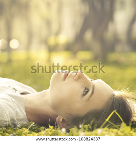 beautiful girl lying on a meadow