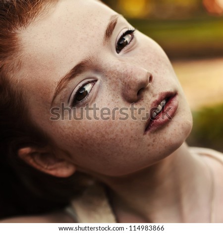 portrait of a beautiful girl with freckles, close-up