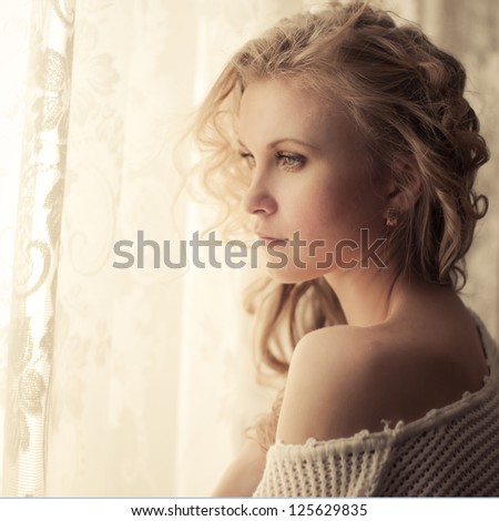 portrait of a beautiful blonde at the window