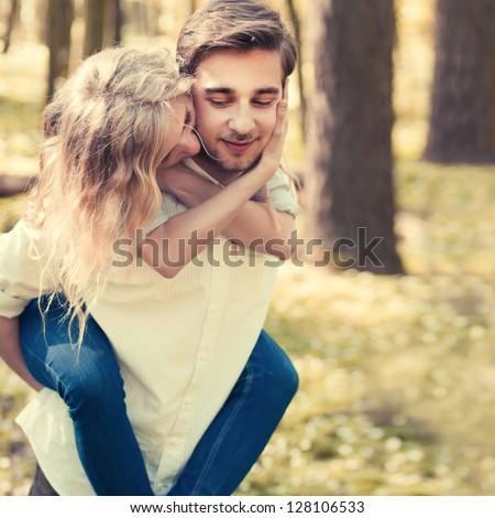 A Young Couple In Love Walking In The Woods