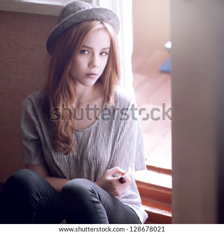 stock-photo-portrait-of-a-beautiful-girl-in-a-hat-girl-is-dressed-in-the-style-of-hipster-128678021.jpg