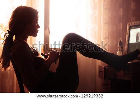 Profile Of Beautiful Girl Sitting In The Room In The Morning