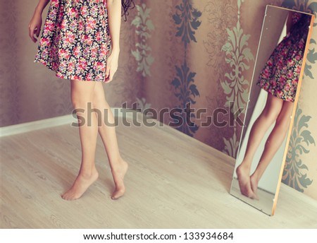 young woman turns the mirror