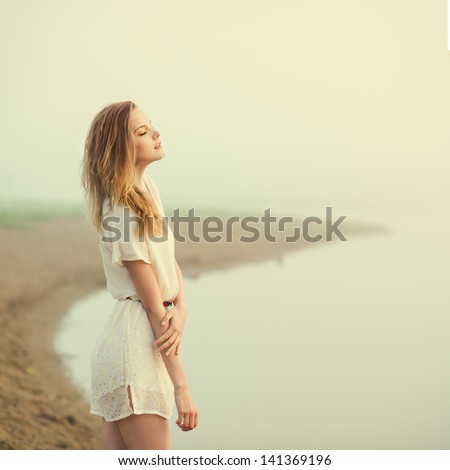 Beautiful Girl On The Beach Alone