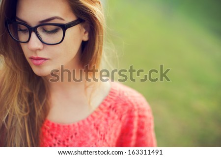 Portrait Of A Beautiful Hipster Girl In Glasses Close Up