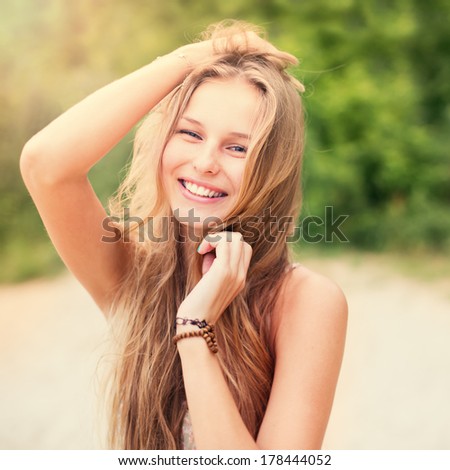 beautiful sunny portrait of a girl. Face laughing girl on beach