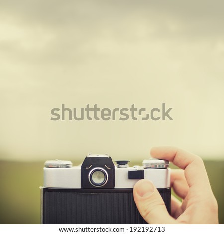 Vintage camera in hand outdoors