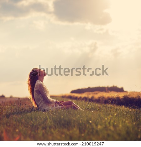 beautiful blonde sitting on a sunset