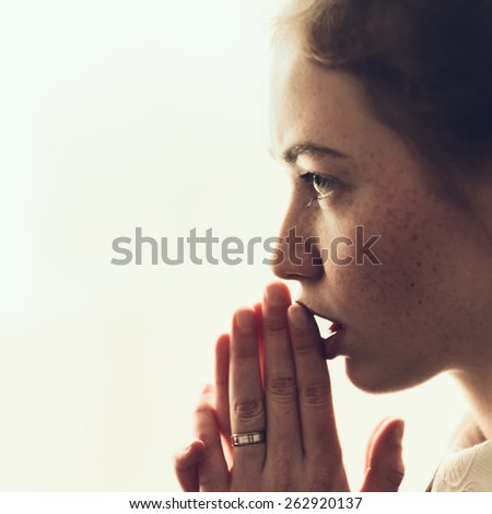 beautiful young girl prays