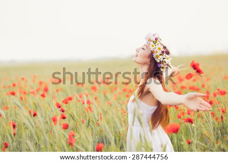beautiful girl in the poppy field