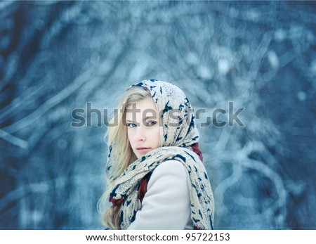 a beautiful young blonde in a winter forest