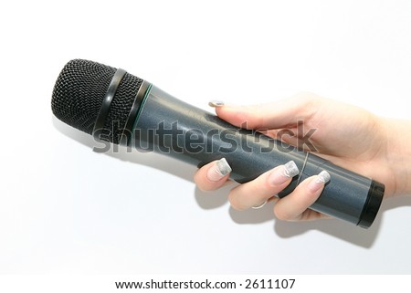 woman\'s hand holding black microphone isolated on white