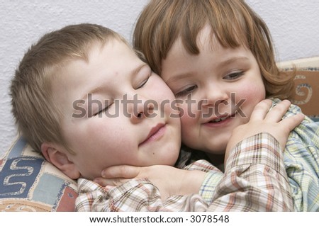 portrait of happy brother and sister, hugging each other with love