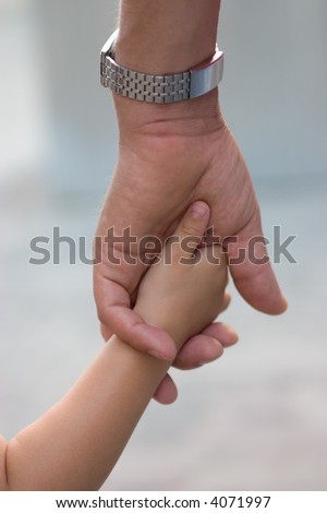 fathers hand holding little child's hand