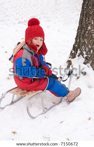 little happy girl having fun in the snow
